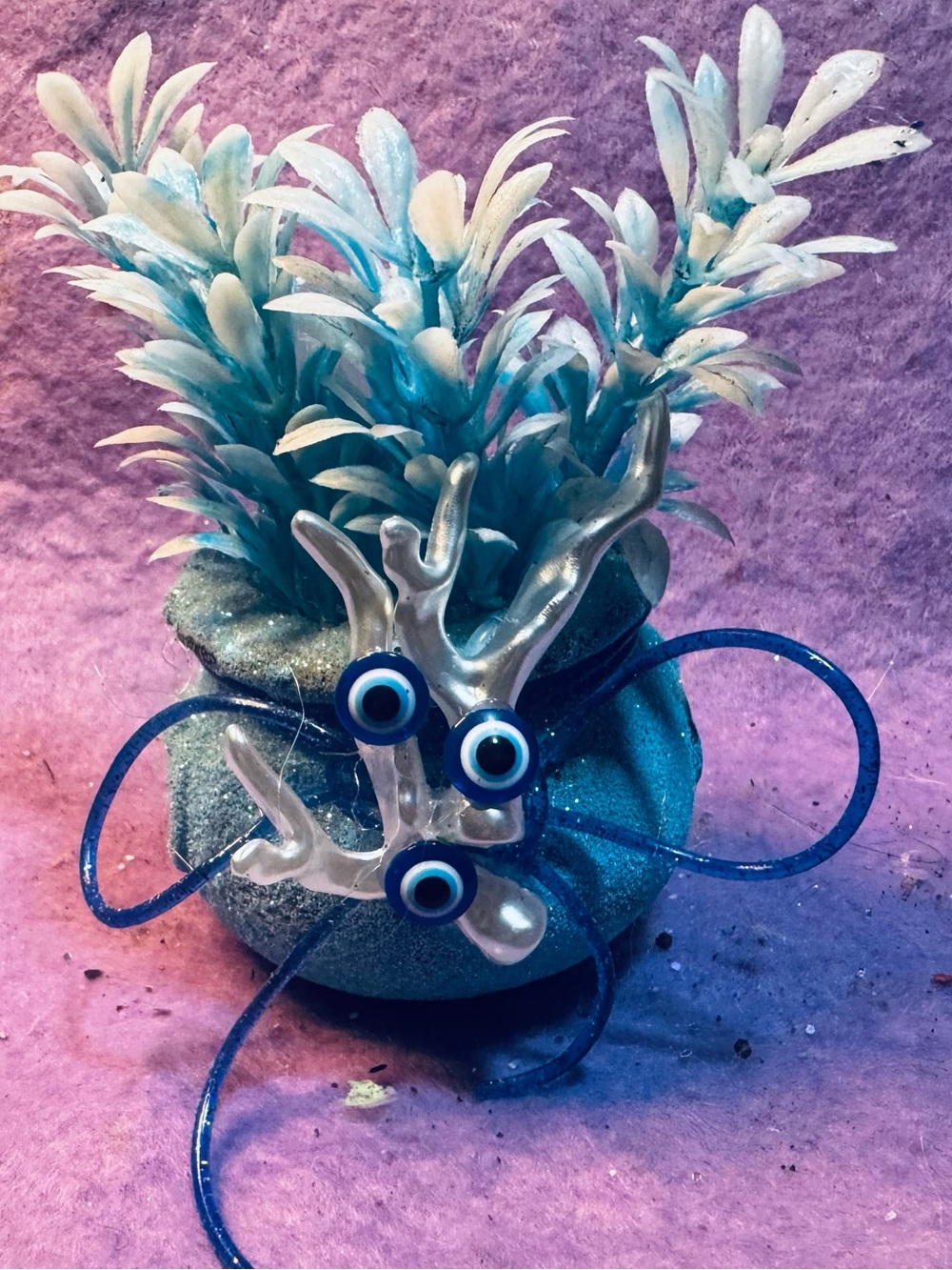 Artificial Plant w/Blue Foliage & Decorative Coral Accent in a mini cauldron